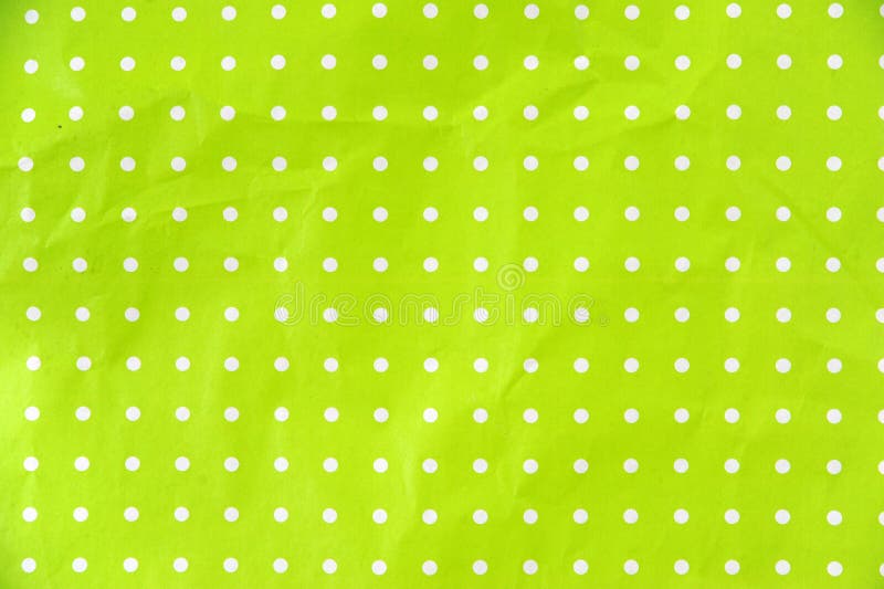 Papel verde-limão com bolinhas brancas foto de stock royalty free