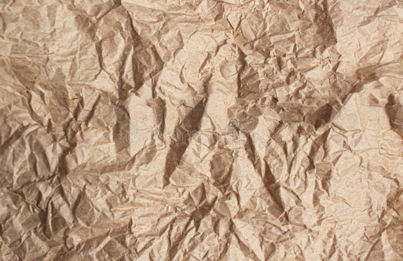 Crumpled brown paper. Background made of natural paper with tears on a white background,. Crumpled brown paper. Background made of natural paper with tears on a white background,