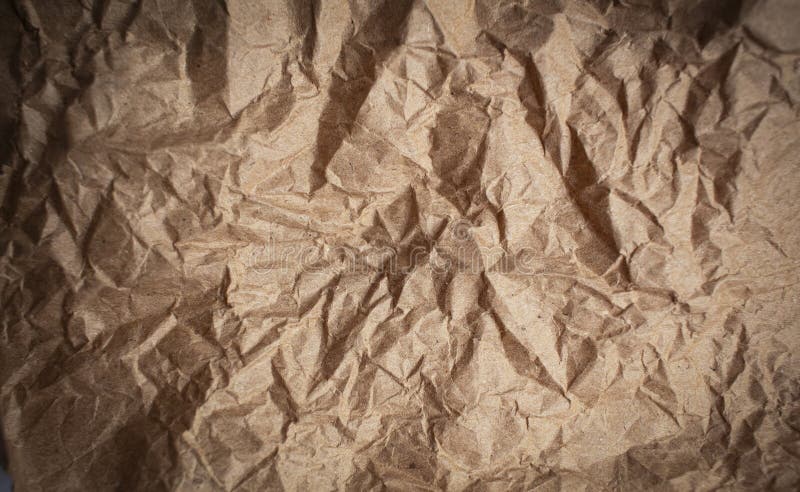 Crumpled brown paper. Background made of natural paper with tears on a white background,. Crumpled brown paper. Background made of natural paper with tears on a white background,