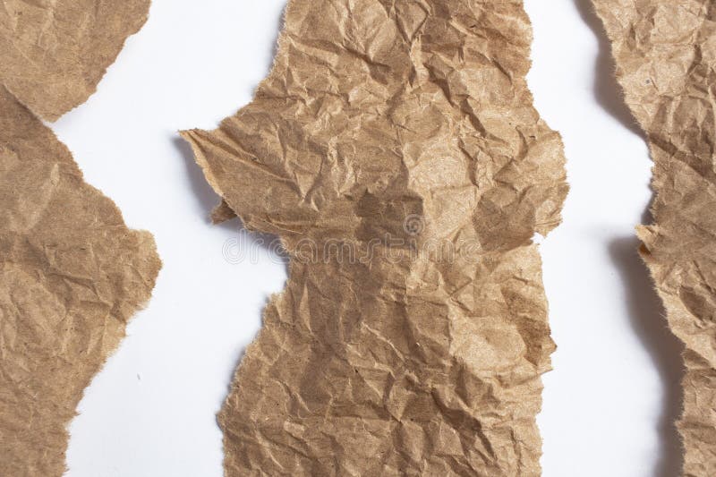 Crumpled brown paper. Background made of natural paper with tears on a white background,. Crumpled brown paper. Background made of natural paper with tears on a white background,