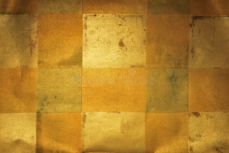 Golden metallic wallpaper with abstract square design, slightly wrinkled with light focused center to ad depth, display sheen. Golden metallic wallpaper with abstract square design, slightly wrinkled with light focused center to ad depth, display sheen.