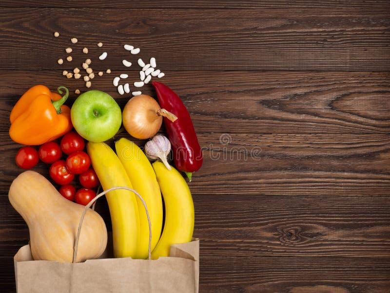 Paper Bag Vegetables And Fruit On A Dark Background Copy Space