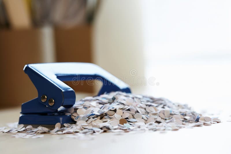 Black paper hole puncher, office tool equipment that is used to create  holes in sheets of paper, isolated on a white background, with clipping  path Stock Photo