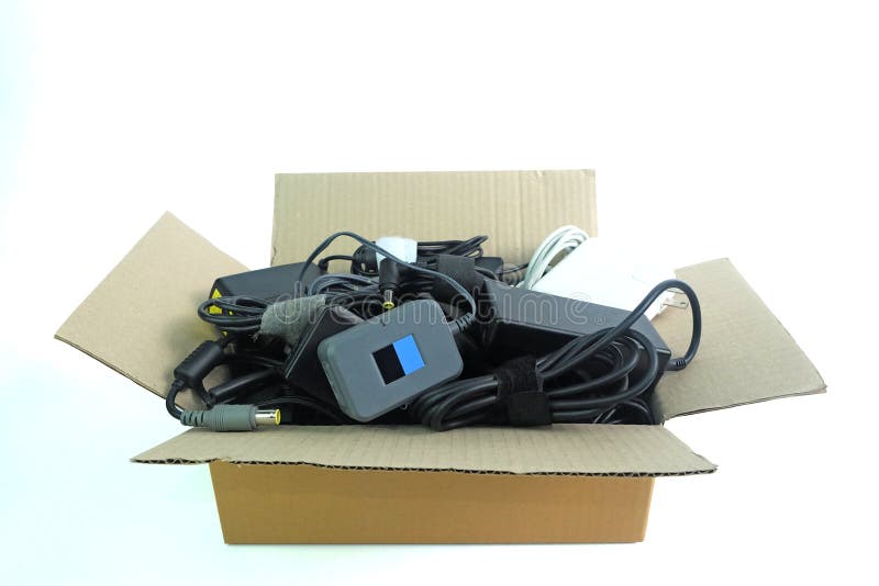 Paper box with the damaged or old used Adapter power charger of laptop computer or electrical appliances on white stock images Paper box with the damaged or old used Adapter power charger of laptop computer or electrical appliances on white stock images