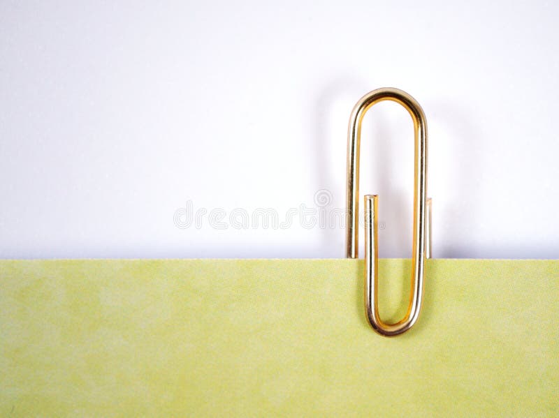 Paper clip,yellow gold metal shiny colorful isolated on white background ,clips color