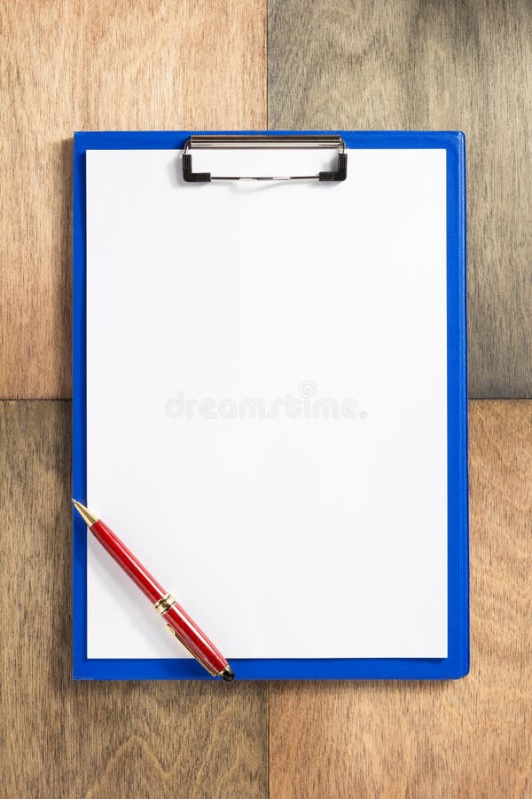 Paper clipboard at wooden background