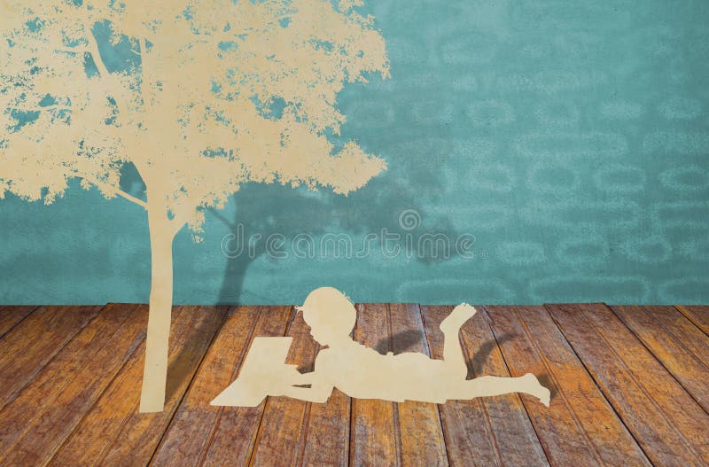 Paper cut of children under tree.