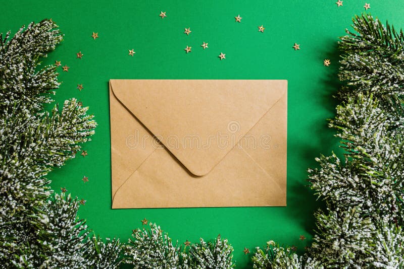 Paper envelope, christmas tree branches on green background with confetti. new year concept. Greeting card, xmas celebration 2020. Paper envelope, christmas tree stock image