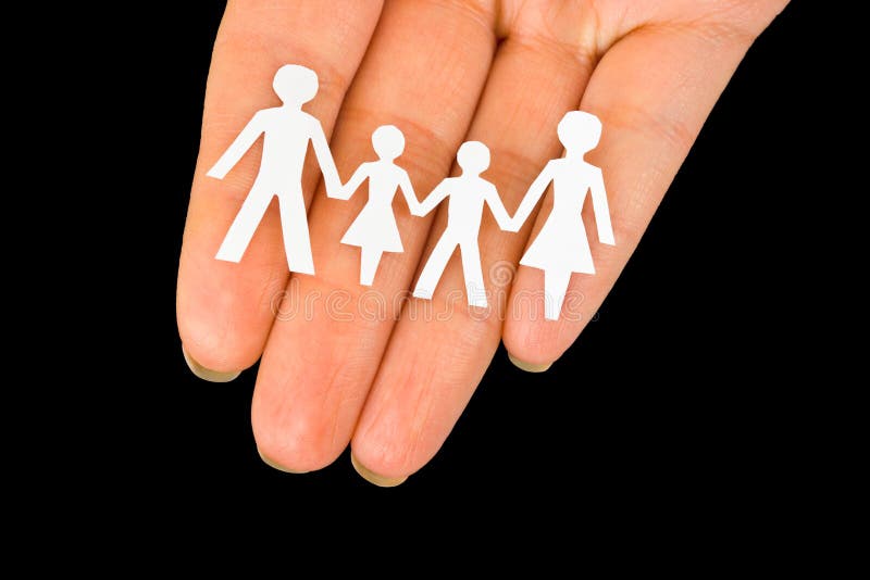 Paper family in hand isolated on black background