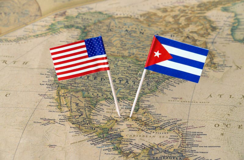 Paper flag pins of the Republic of Cuba and the United States of America on a world map. Concept image of political or diplomatic relations. Paper flag pins of the Republic of Cuba and the United States of America on a world map. Concept image of political or diplomatic relations