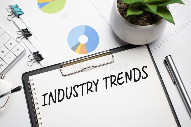Paper with INDUSTRY TRENDS on the Table, Calculator and Money Stock