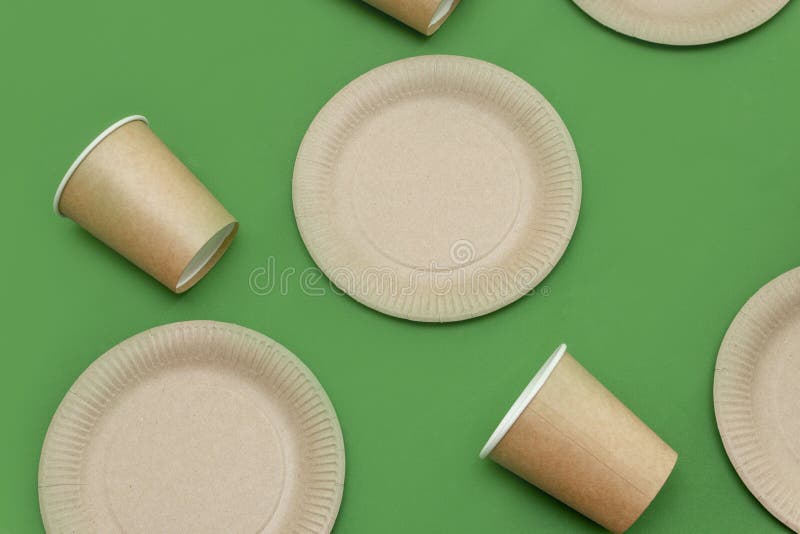 Premium Photo  Paper plate, glass on a green background. eco