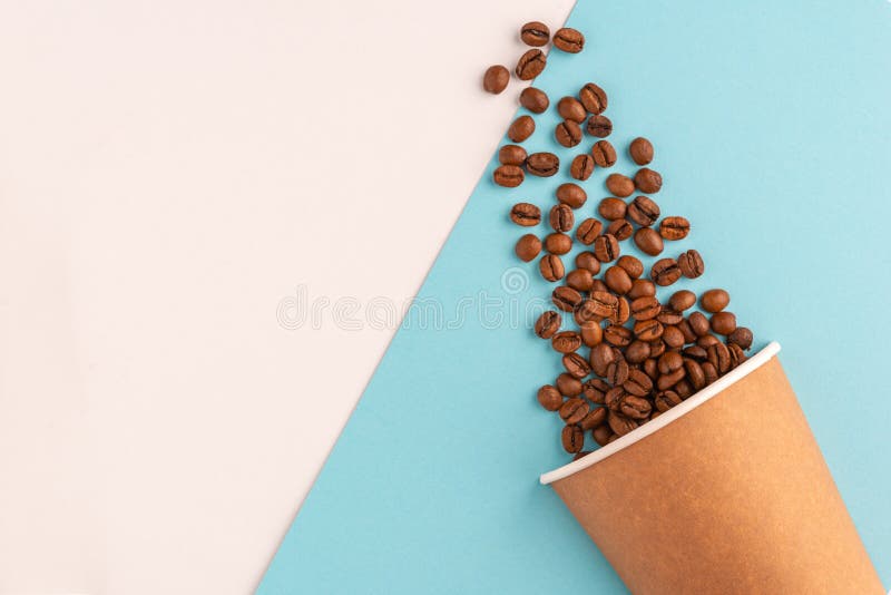 Paper Recyclable Cup with Scattered Coffee Beans on a Blue and White