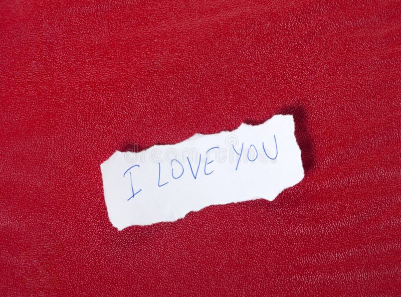 Paper on red background with message of love