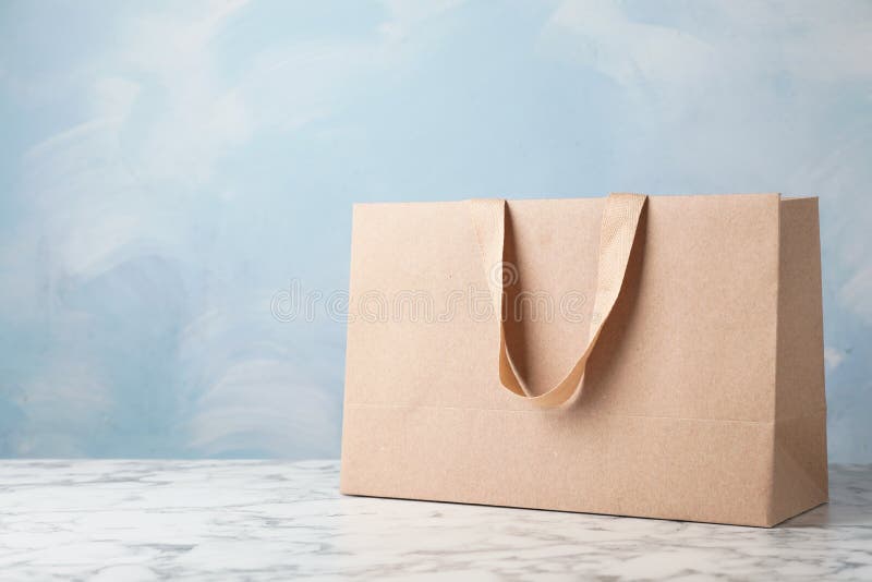 Download Blank Brown Shopping Bag On Table With Blue Background ...