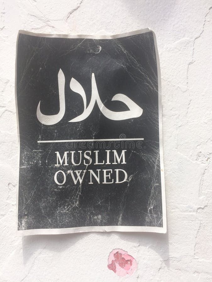 Paper sign with the text & x22;Muslim owned& x22; hanging on a wall on the Haji Lane in Singapore