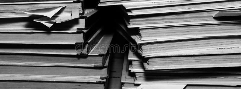 Paper documents stacked in archive. Documents on the shelves of archive room. Office shelves in the closet full of files. black and white photo. Paper documents stacked in archive. Documents on the shelves of archive room. Office shelves in the closet full of files. black and white photo