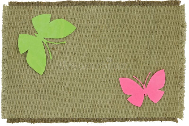 Homemade cardboard butterfly on green coarse cloth. Isolated object on a white background. Homemade cardboard butterfly on green coarse cloth. Isolated object on a white background.