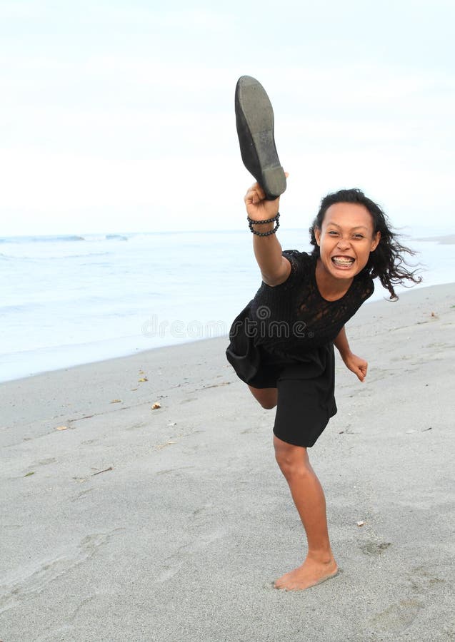 Papuan girl throwing a shoe