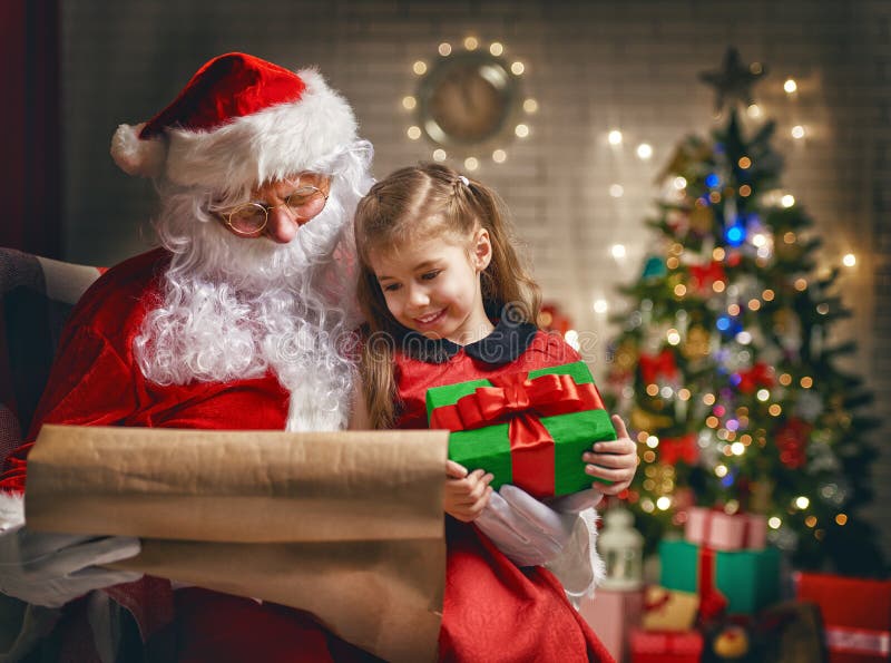 Papá Noel y niña fotografía de archivo
