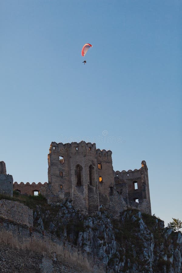 Para glider flying above ruined castle - Modern technology over medieval architecture