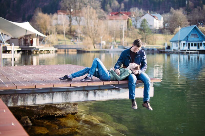 Soft portrait of young lovely couple spending time on berth. Soft portrait of young lovely couple spending time on berth