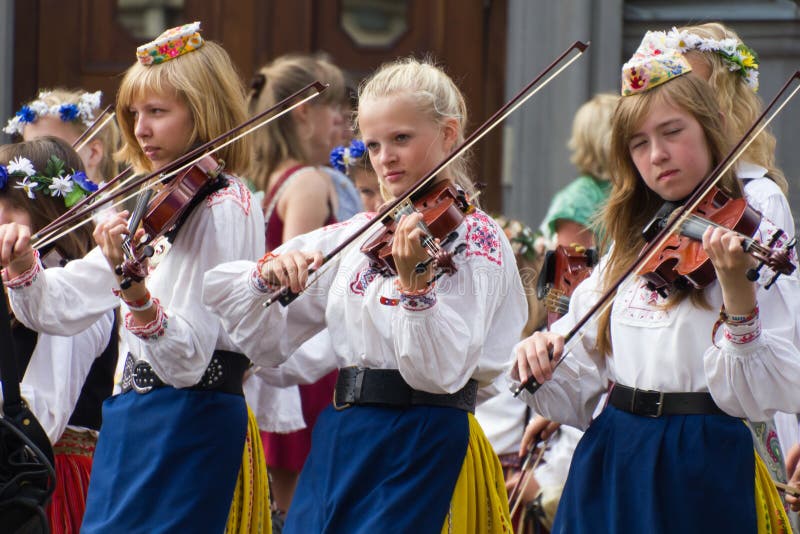 Tallinn, Estonia - July 3, 2011 :: The Parade of the 11th Youth Song and Dance Celebration in Tallinn. Total of 22239 singers and 2111 orchestra players, marching toward the concert place - Tallinn Song Festival Grounds, wearing national costumes, singing and rejoicing. Folklore costumes stock images, royalty-free photos and pictures