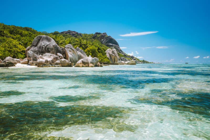 Anse Source d&#x27;Argent - Paradise like tropical beach. Shallow lagoon in low tide time, Granite boulders and palm trees. La Digue island, Seychelles. Anse Source d&#x27;Argent - Paradise like tropical beach. Shallow lagoon in low tide time, Granite boulders and palm trees. La Digue island, Seychelles.