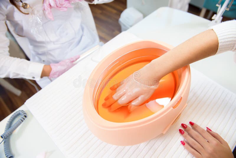 Paraffin Bath. Spa Salon. Manicure. Process Paraffin Treatment. Stock