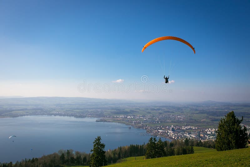 Paraglider over the Zug city, Zugersee and Swiss Alps