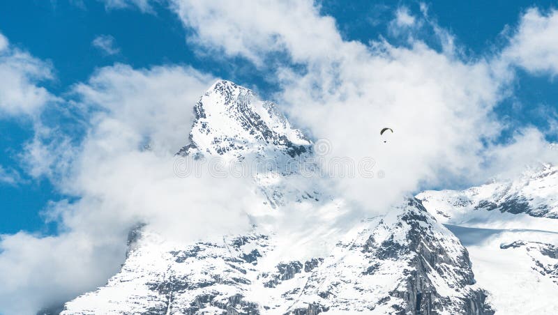 Switzerland - May 2017: Paragliding above the Alp mountains