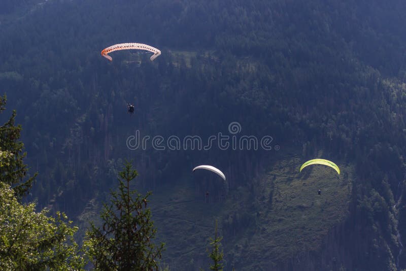 Paragliding flying over Mont Blanc Massif, in the background are Aiguilles du Chamonix, Alps, Chamonix, France royalty free stock image Paragliding flying over Mont Blanc Massif, in the background are Aiguilles du Chamonix, Alps, Chamonix, France royalty free stock image