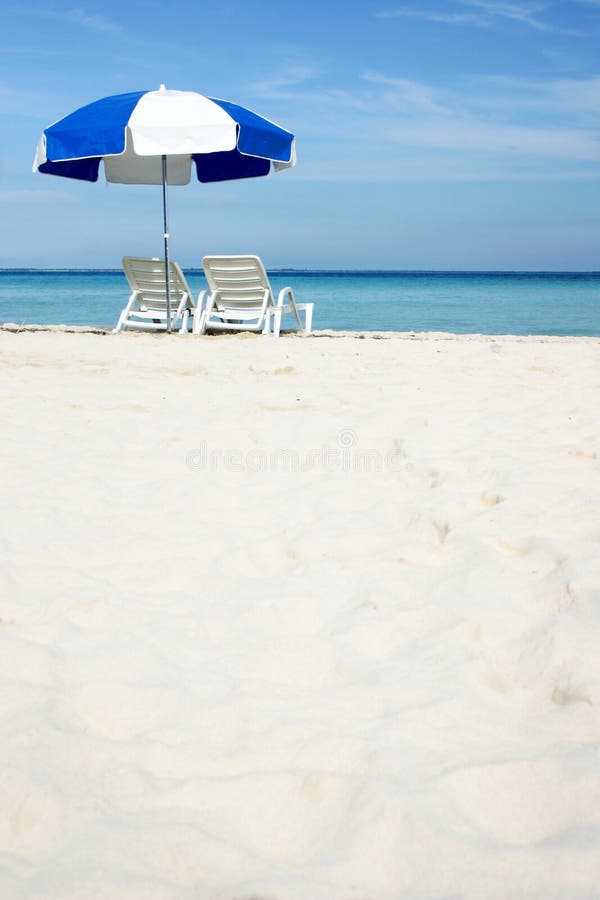 Umbrella on white sand beach; one of a series. Umbrella on white sand beach; one of a series