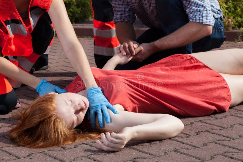 Paramedic helping unconscious woman stock photos Paramedic helping unconscious woman stock photos