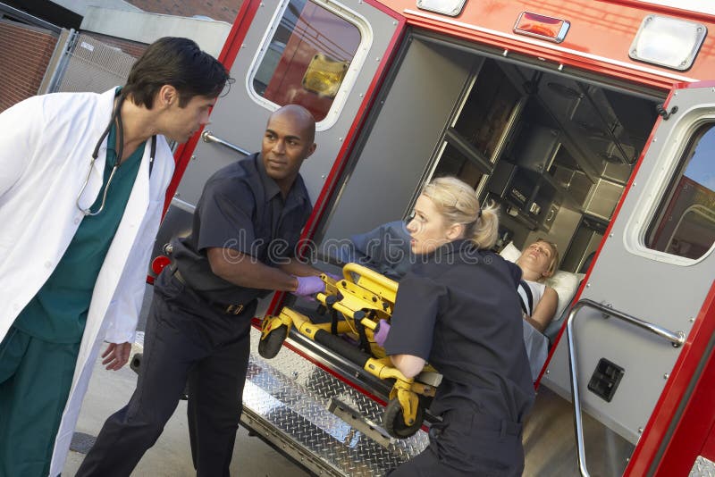Paramedic preparing to unload patient stock image