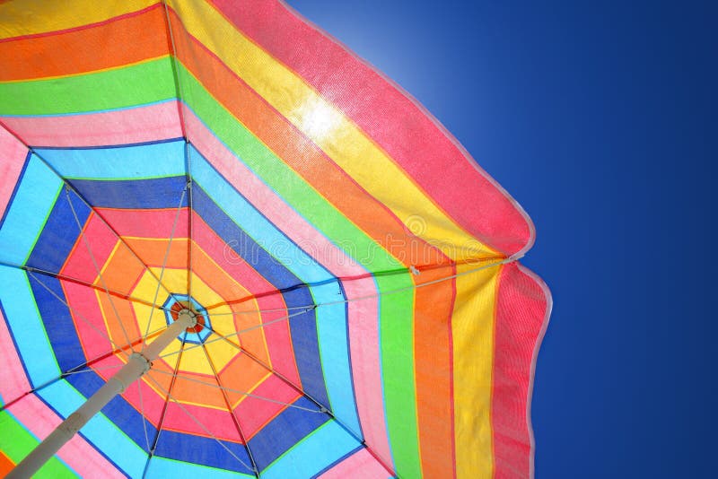Beach umbrella against a sunny blue sky. Travel & Vacation Collection. Beach umbrella against a sunny blue sky. Travel & Vacation Collection.