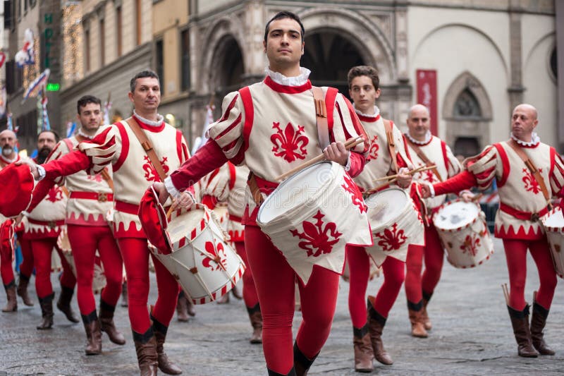 Florence, Tuscany, Italy - January 6, 2018: drummer in traditional red and white costumes parades in the Piazza Duomo, during the historical recreation of the `Procession of the Magi`. Florence, Tuscany, Italy - January 6, 2018: drummer in traditional red and white costumes parades in the Piazza Duomo, during the historical recreation of the `Procession of the Magi`