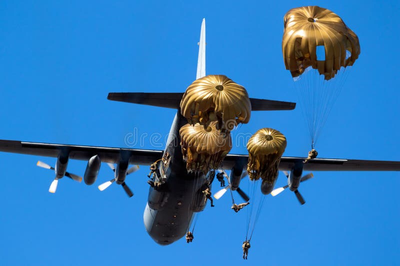 Paratroopers jumping out of a military transport plane