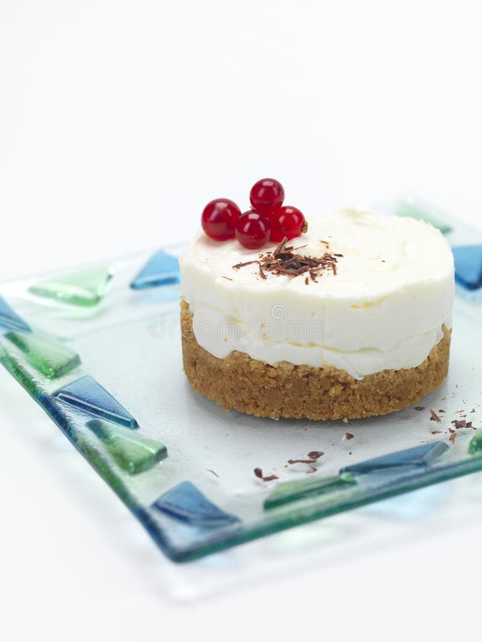 A cheese cake decorated with cranberries and chocolate flakes. A cheese cake decorated with cranberries and chocolate flakes