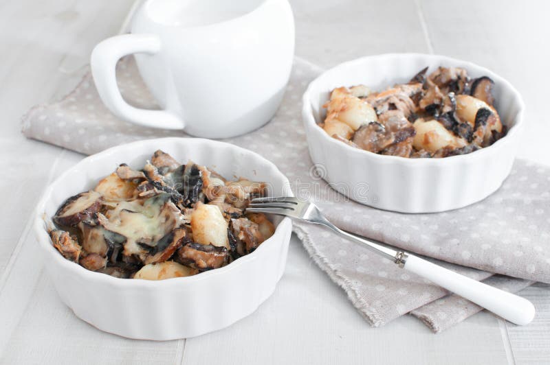 Portions of baked tuna with mushrooms and cheese. Portions of baked tuna with mushrooms and cheese
