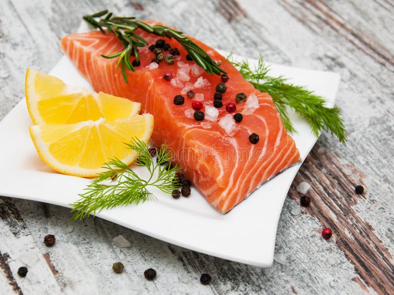 Portions of fresh salmon fillet with aromatic herbs, spices and vegetables. Portions of fresh salmon fillet with aromatic herbs, spices and vegetables