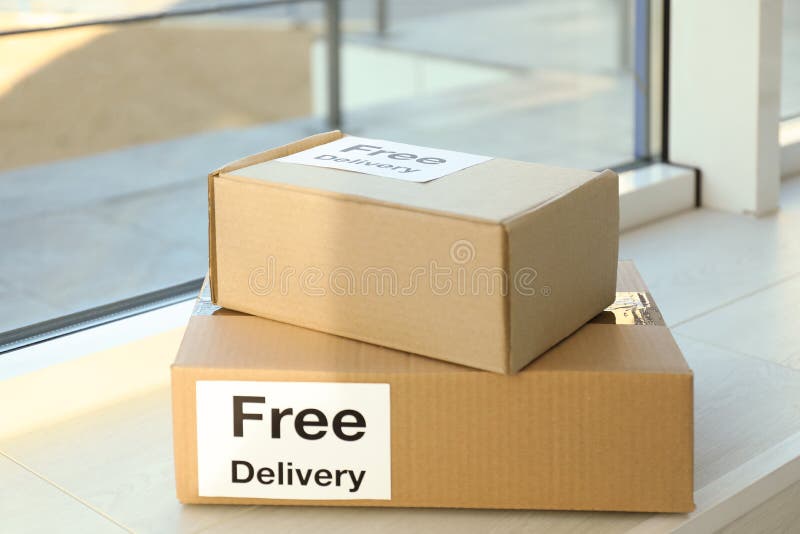 Parcels with sticker Free Delivery on window sill royalty free stock photography