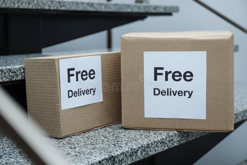 Parcels with stickers Free Delivery on stairs stock image