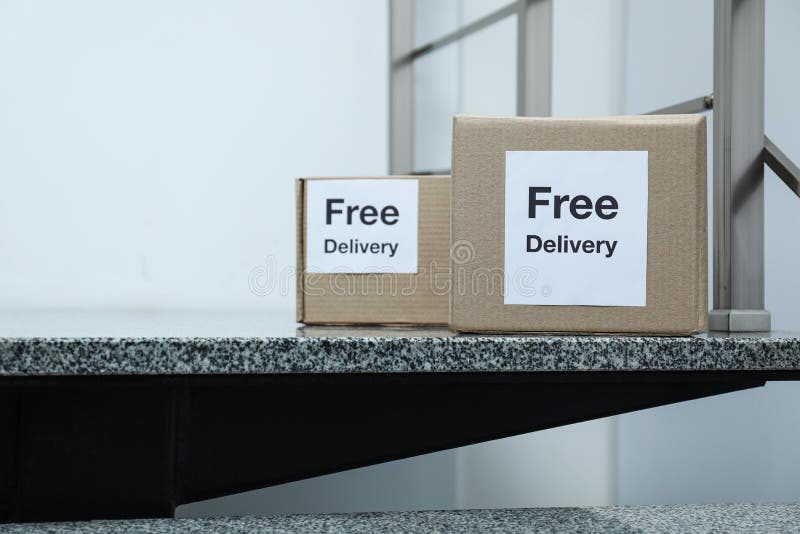 Parcels with stickers Free Delivery. Courier service stock photos