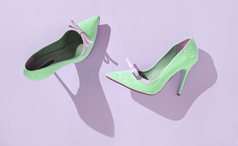 Pare of Light Green High Heel Shoes on Purple Background with Shadows ...