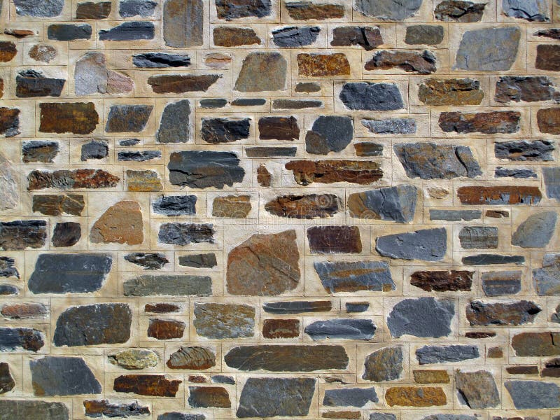 Pared de piedra geométrica decorativa imagenes de archivo