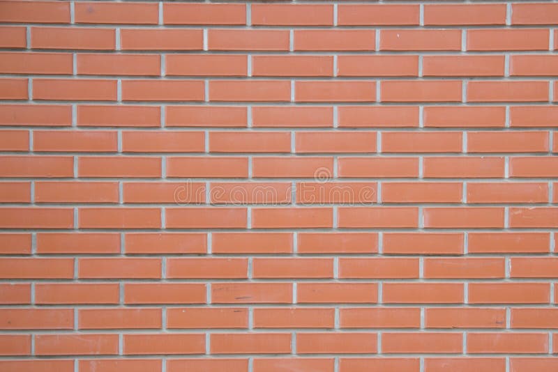 A parede de tijolo marrom vermelha do bloco arranjou belamente o fundo da textura foto de stock A parede de tijolo marrom vermelha do bloco arranjou belamente o fundo da textura foto de stock