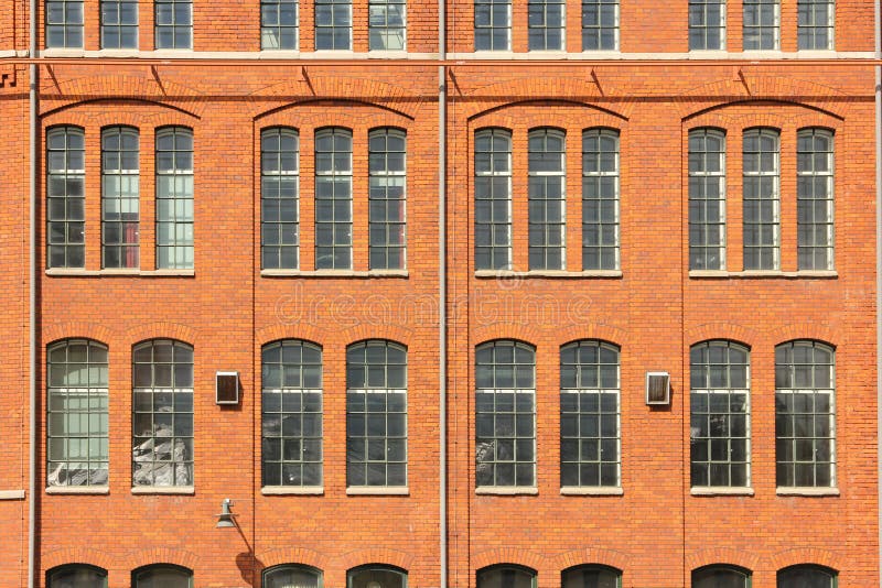 Detail of a factory red brick wall and windows in the old industrial area. Norrkoping. Sweden. Detail of a factory red brick wall and windows in the old industrial area. Norrkoping. Sweden