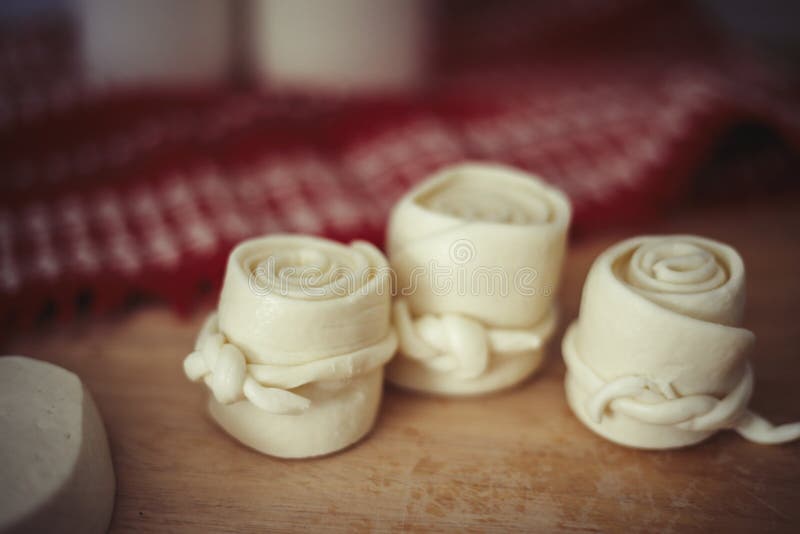 Parenica, traditional Slovak cheese rolls on wooden table background. Home made rolled cheese, sheep milk product