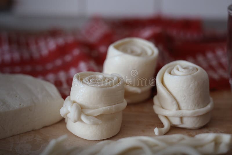 Parenica, traditional Slovak cheese rolls on wooden table background. Home made rolled cheese, sheep milk product